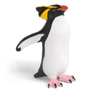 Pinguino Schleich che gioca con la figura del pinguino saltaroccia giocattolo della fauna selvatica.