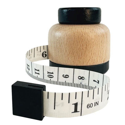 Egmont measuring tape in wooden holder. fsc.