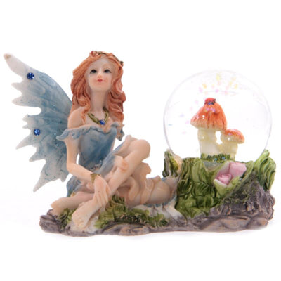 Flower Fairy seduto con un globo di neve