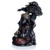 Ganesh in oro nero seduto sotto l'albero